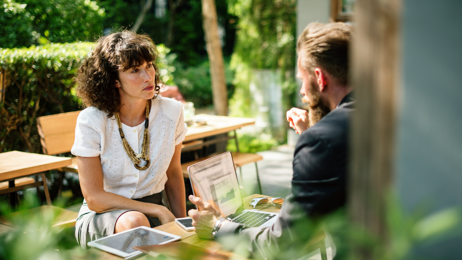 A focused one-to-one conversation in a relaxed outdoor setting